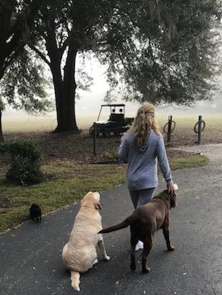 Debbie Miley on a walk with baby Bitcoin (left) and the dogs 