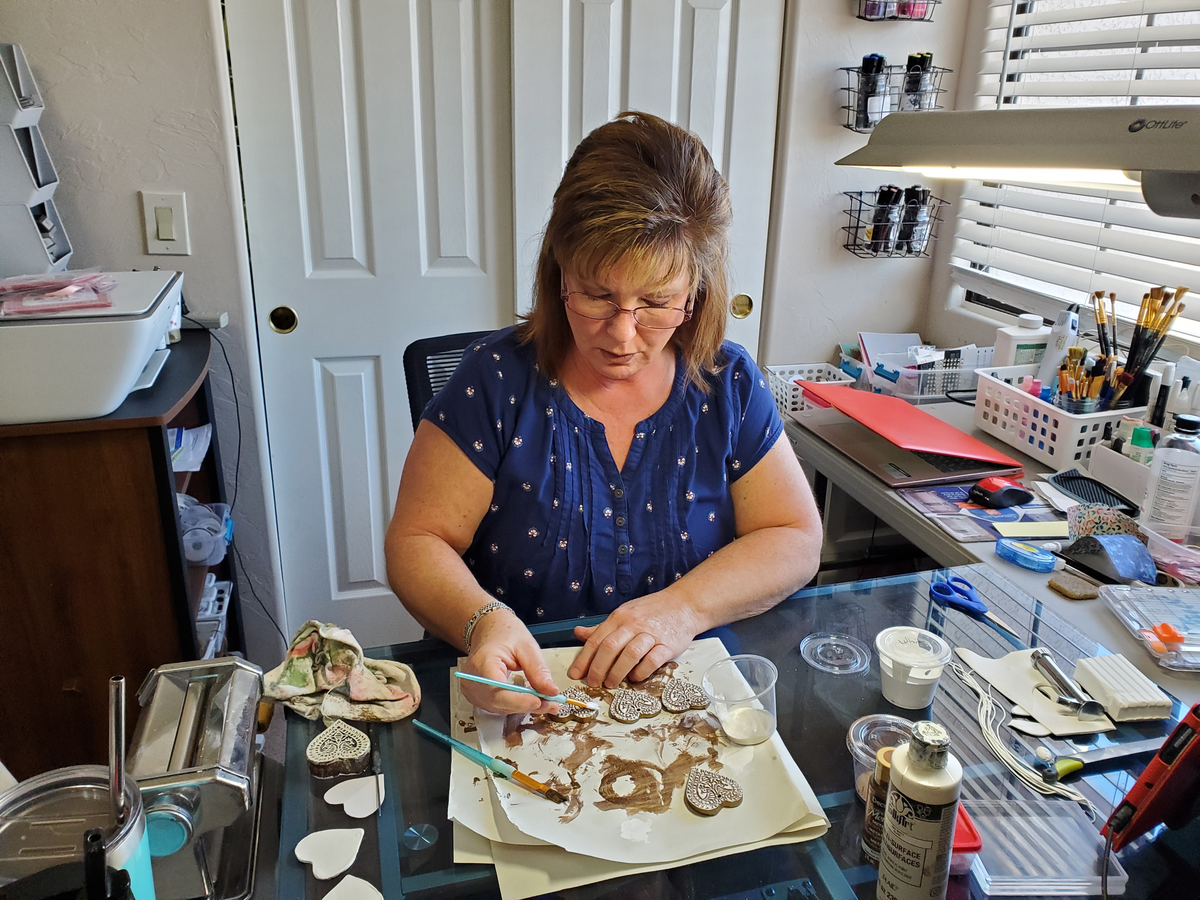 An artist crafting hearts in their workshop