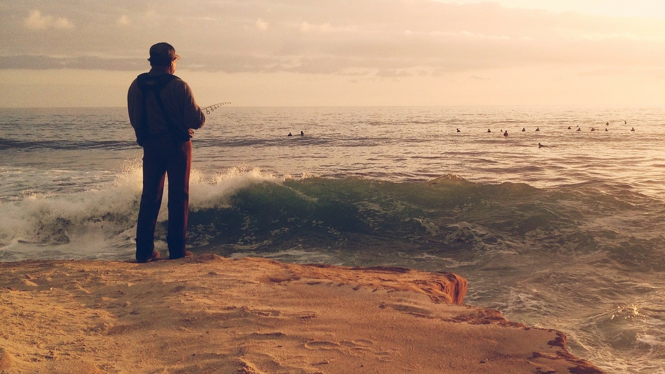 man fishing on a beach