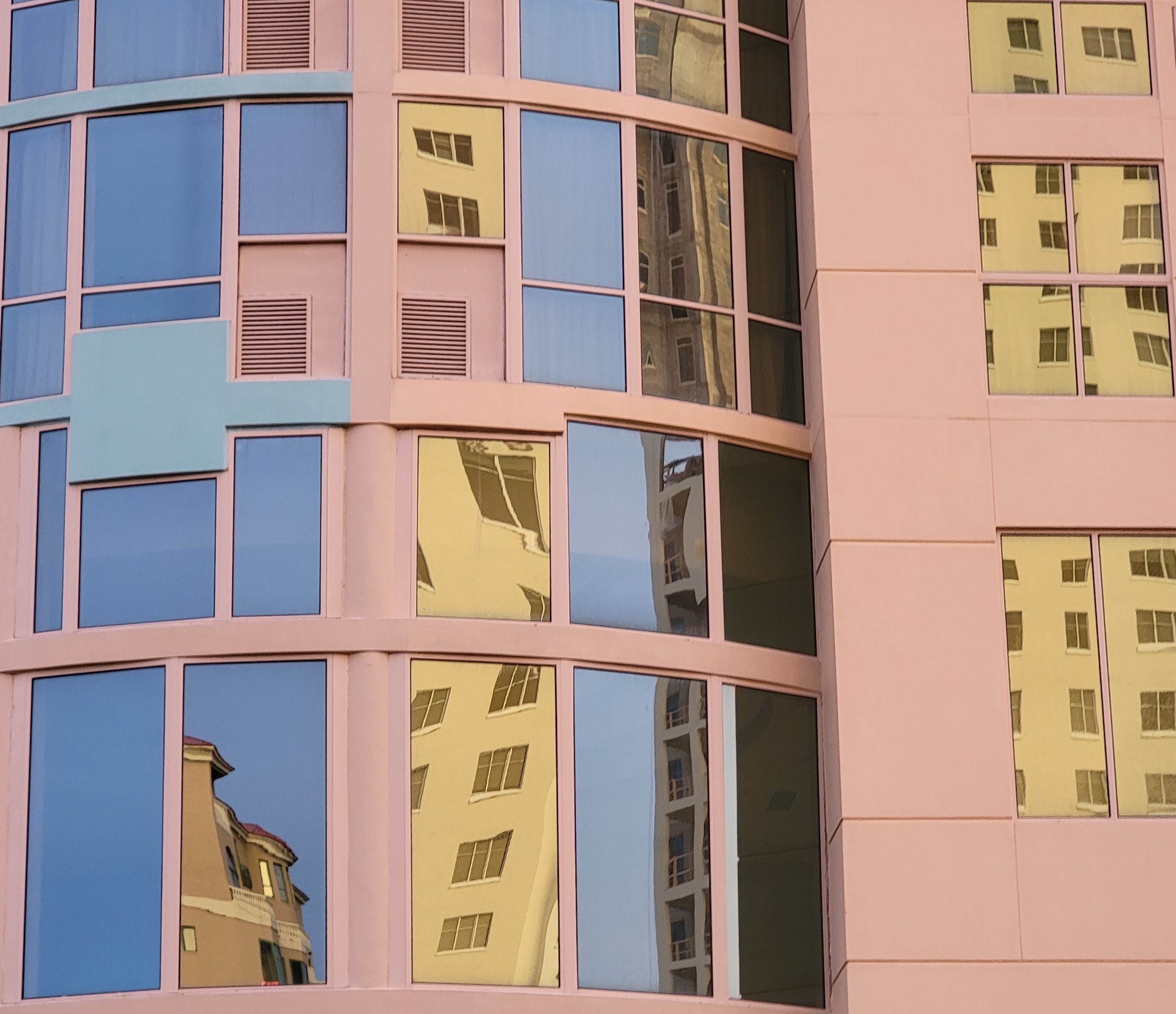 It looked like a crazy stairway climbed up the building, with carnival yellow windows playing peekaboo.