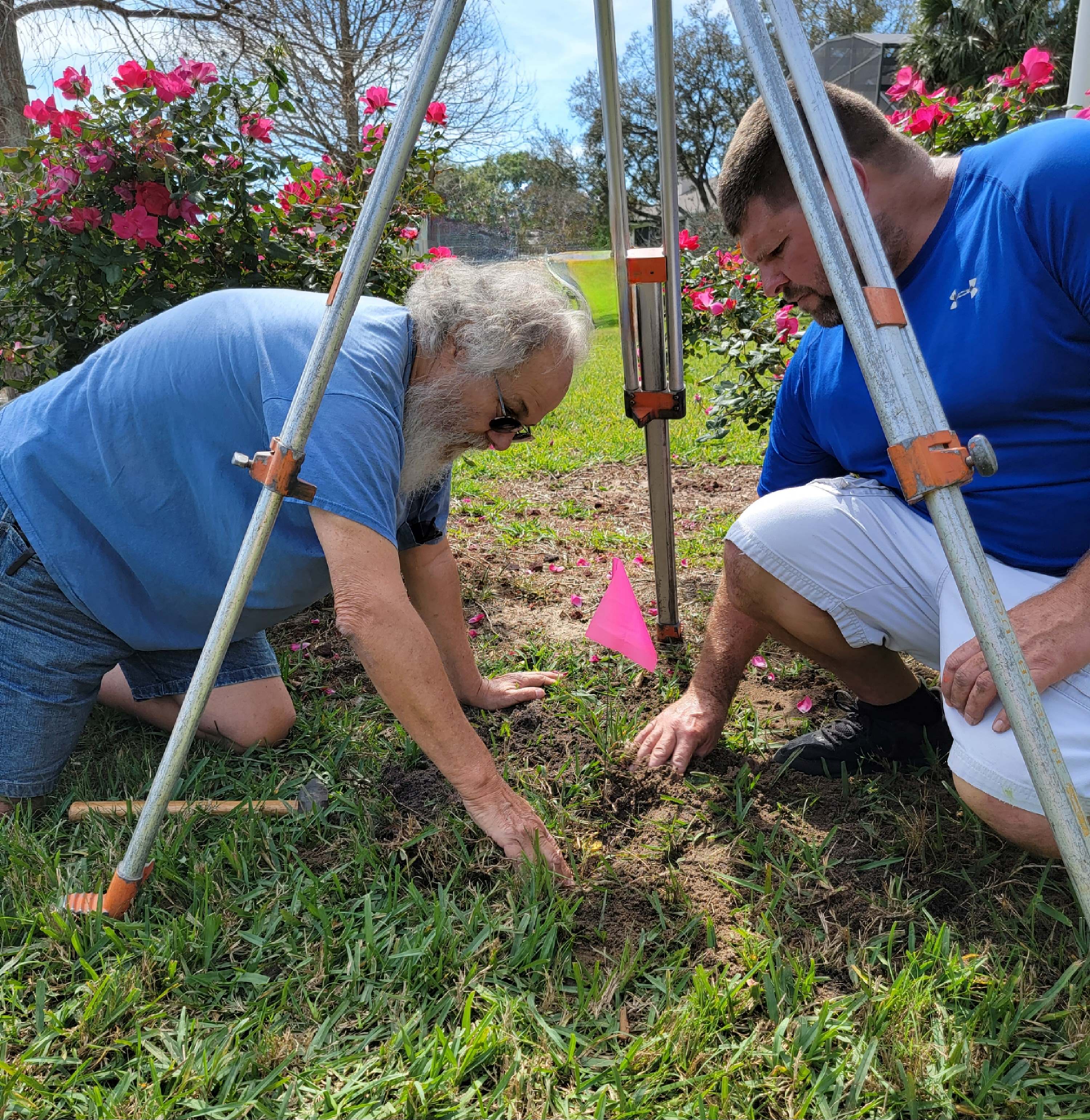 Father and son surveyors locate boundaries